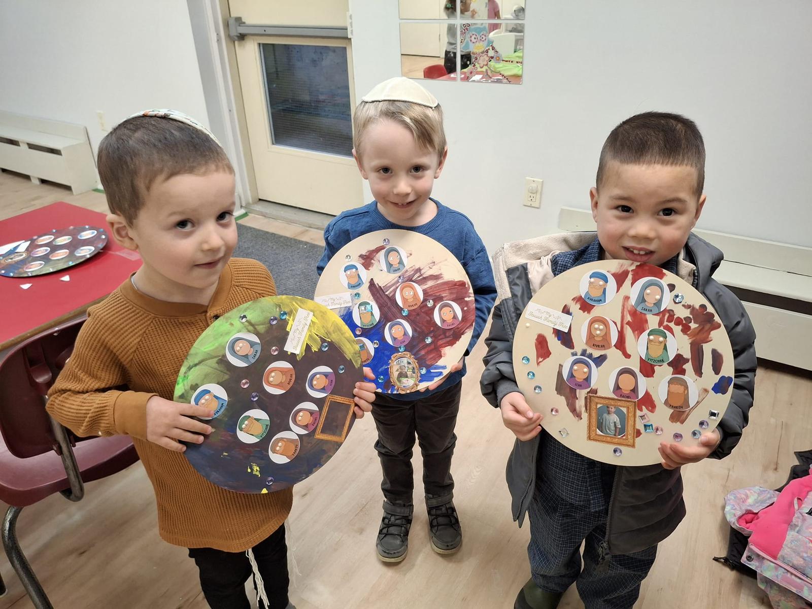 Younger Hebrew School students proudly holding their projects